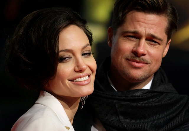 U.S. actors Brad Pitt and his partner Angelina Jolie pose for photographers on the red carpet at the German premiere of the movie "The Curious Case of Benjamin Button" in Berlin January 19, 2009. (Photo: Reuters/ File Photo)