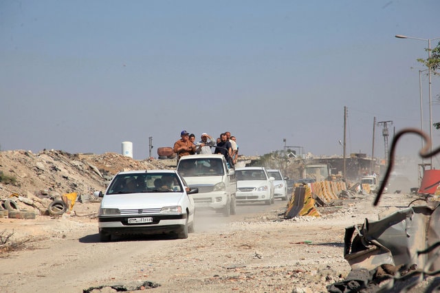People drive in the Ramousah area of southern Aleppo, after the Syrian army and allied militia advanced in the area, Syria. (Photo: SANA/Handout via Reuters)