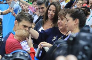 Michael Phelps greets his mother Debbie, fiancé Nicole Johnson and their son Boomer after he won the gold medal. (Photo: Reuters)