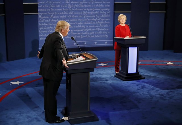 Republican U.S. presidential nominee Donald Trump speaks as Democratic U.S. presidential nominee Hillary Clinton listens. (Photo: Reuters)