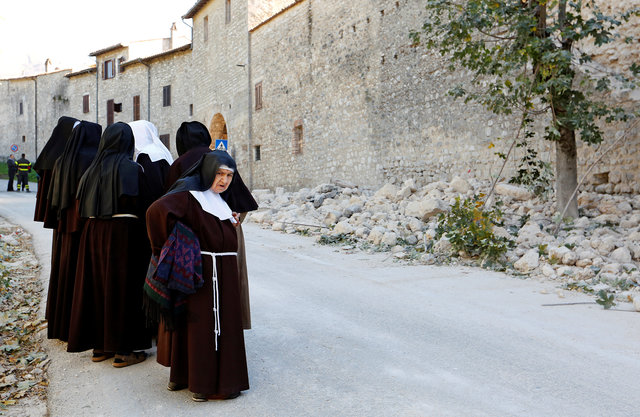 Nuns stand next a partially collapsed wall following an earthquake in Norcia, Italy, October 30, 2016. (Photo: Reuters)