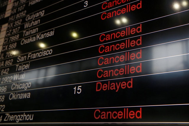 A panel displaying cancelled and delayed flights is seen at a downtown check-in centre as Typhoon Haima approaches in Hong Kong, China, October 21, 2016. (Photo: Reuters)