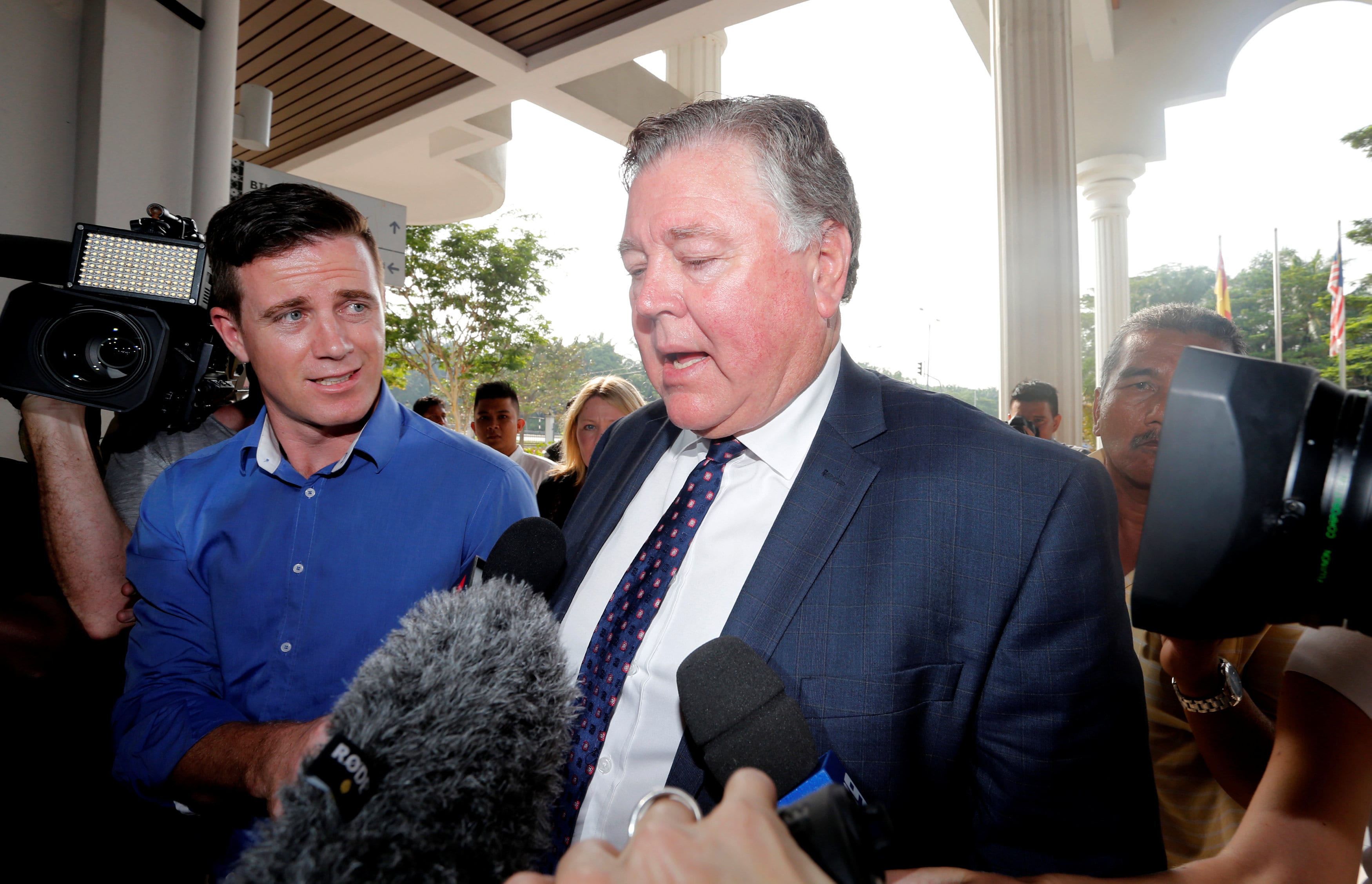 John Walker (C), father to Jack Walker, one of the nine Australian men who were detained for stripping down to their underwear at last Sunday's Formula One Malaysian Grand Prix, talks to journalists as he arrives at the Magistrate Court in Sepang, Malaysia October 6, 2016.  (Photo: Reuters)