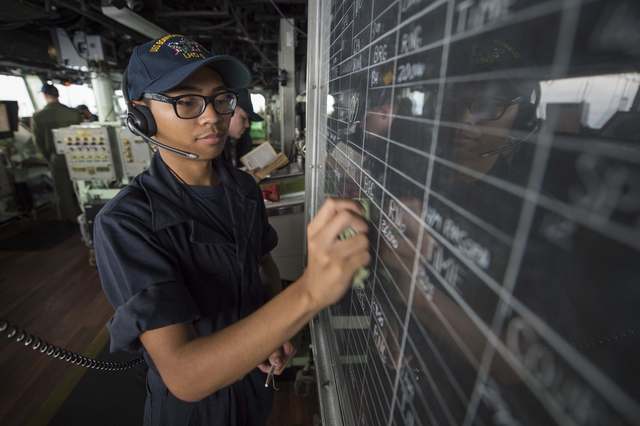 Seaman Kyren Mounsombath updates navigational information on the bridge of the amphibious assault ship USS Bonhomme Richard (LHD 6), flagship of the Bonhomme Richard Expeditionary Strike Group, in the South China Sea on October 12, 2016. Picture taken on October 12, 2016. (Photo: US Navy/Handout via Reuters)