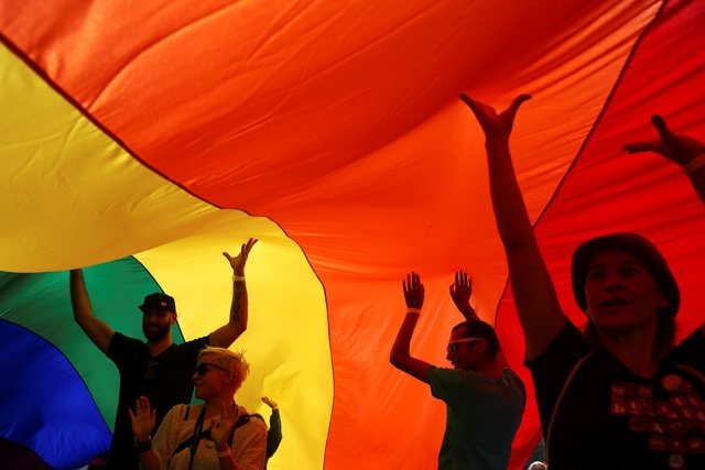 Participants dance under a rainbow flag during an annual LGBT pride parade in Belgrade, Serbia. (Photo: Reuters)