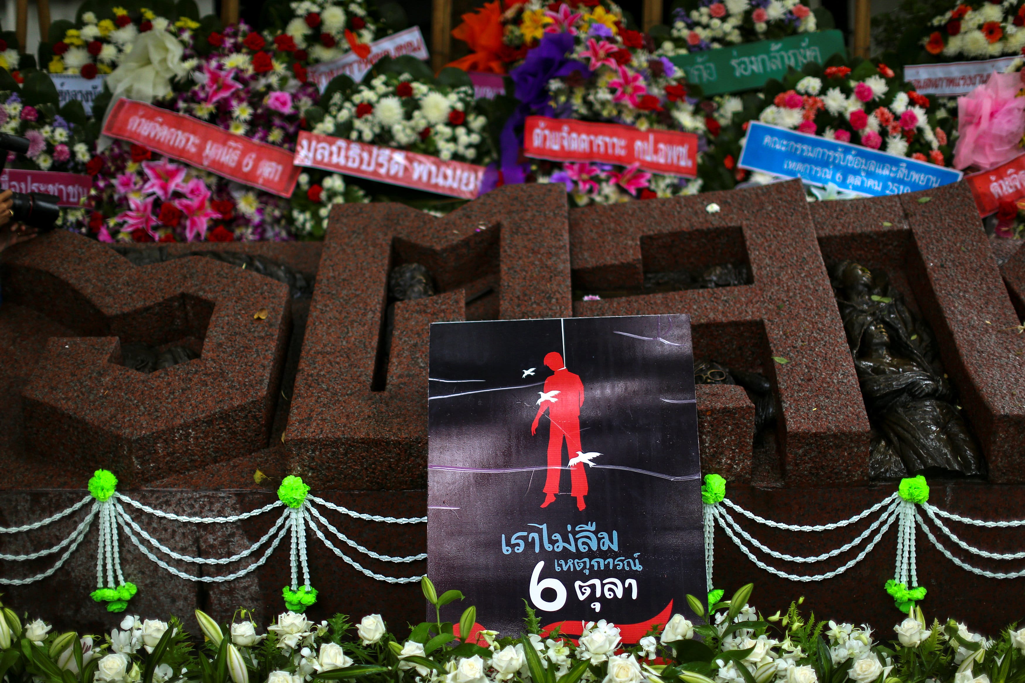 A poster is placed on a memorial during the anniversary. It reads, "We will not forget October 6". (Photo: Reuters)
