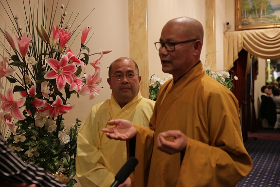 Venerable Thich Phuoc Tan (L) and Venerable Thich Thien Tam (R) representing The Unified Vietnamese Buddhist Congregation of Australia and New Zealand, talk to TiVi Tuan-san in an interview at Happy Receptions restaurant, Ascot Vale, Melbourne. (Photo: Reuters)