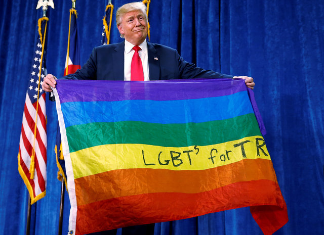 Republican presidential nominee Donald Trump holds up a rainbow flag with "LGBT's for TRUMP" written on it at a campaign rally in Greeley, Colorado, US October 30, 2016. (Photo: Reuters)