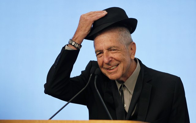 Musician Leonard Cohen tips his hat to the audience as he accepts the 2012 Awards for Song Lyrics of Literary Excellence, which was awarded to both he and Chuck Berry at the John F. Kennedy Presidential Library and Museum, in Boston, Massachusetts, U.S. on February 26, 2012. (Photo: Reuters/ Jessica Rinaldi/ File Photo)