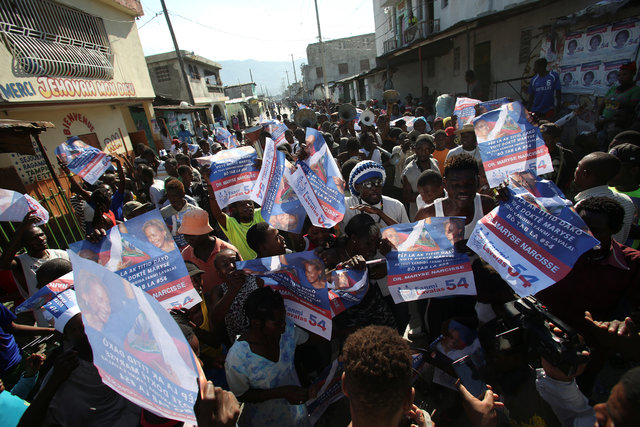 Supporters of presidential candidate Maryse Narcisse, of Fanmi Lavalas party, hold posters during a protest in Port-au-Prince, Haiti, November 29, 2016. (Photo: Reuters)
