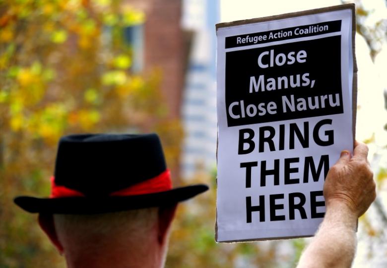 A protester from the Refugee Action Coalition holds a placard during a demonstration outside the offices of the Australian Government Department of Immigration and Border Protection in Sydney, Australia, April 29, 2016.  REUTERS/David Gray/File Photo
