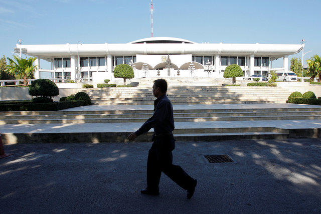 An official walks past the Parliament where members of the National Legislative Assembly will take part in a meeting to invite Crown Prince Maha Vajiralongkorn to become the country's new king. (Photo: Reuters)