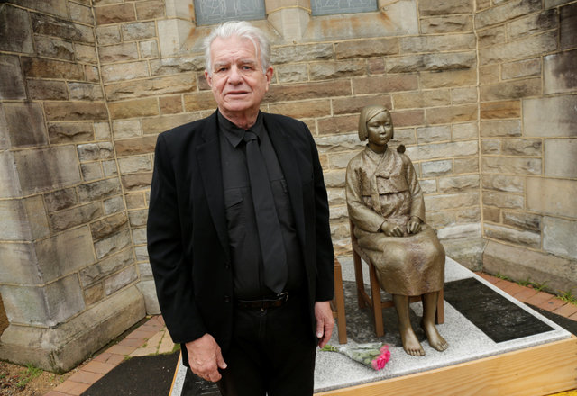 Reverend Bill Crews poses in front of the statue. (Photo: Reuters)
