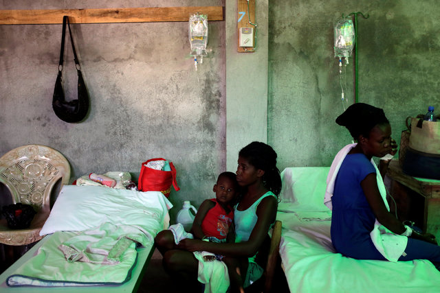 A woman takes care of her son, who is receiving treatment for cholera, at the Immaculate Conception Hospital in Les Cayes, Haiti, November 8, 2016. (Photo: Reuters)