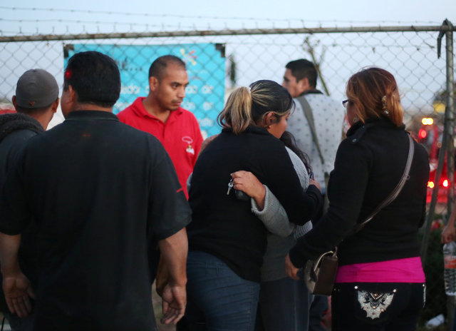 People hug after an explosion at the San Pablito fireworks market outside the Mexican capital on Tuesday, in Tultepec, Mexico, December 20, 2016. (Photo: Reuters)