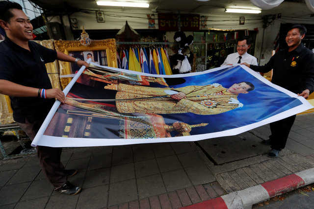 Officials buy a picture of Crown Prince Maha Vajiralongkorn for their office, at a royal memorabilia shop in Bangkok, Thailand, December 1, 2016. (Photo: Reuters)